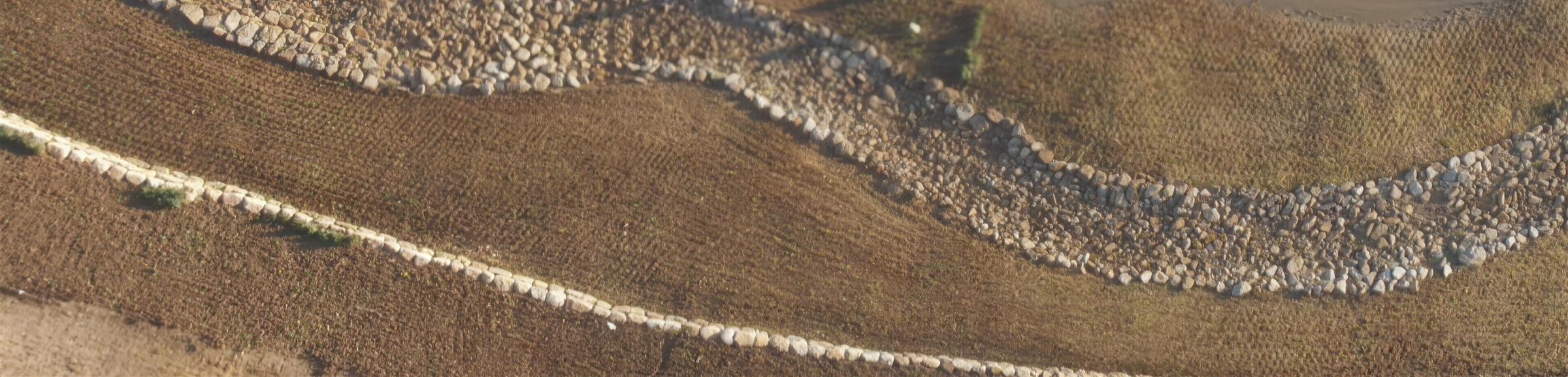 Aerial view of completed erosion control and revegetation works along a waterway